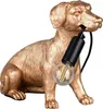 A golden dog-shaped lamp with a light bulb in its mouth, set against a white background. Voir les images du produit