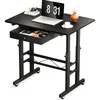 A black adjustable height desk with a laptop, books, and a vase on top, and a drawer pulled out. Anteprima dell’immagine prodotto
