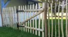 A wooden garden gate made of hazelnut wood, installed in a fence in a grassy yard. Anteprima dell’immagine prodotto