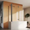A modern bathroom with a bathtub and a glass shower screen. Produktbild-Vorschau