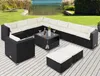 An outdoor patio set with a sectional sofa, coffee table, and ottomans arranged on a wooden deck next to a body of water and grass. Produktbild-Vorschau