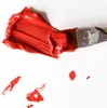A close-up shot of red paint being applied with a brush on a white surface. Podgląd zdjęcia produktu