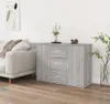 A gray sideboard with drawers and doors is placed in a living room next to a sofa. Voir les images du produit