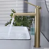 A modern bathroom sink with a gold faucet. Anteprima dell’immagine prodotto