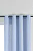 A close-up view of light blue curtains hanging from a curtain rod. Produktbild-Vorschau