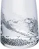 A close-up shot of cleaning beads at the bottom of a glass with water swirling above them. Anteprima dell’immagine prodotto