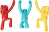 Three colorful wall hooks shaped like cartoon people hanging. Anteprima dell’immagine prodotto