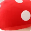 A close-up view of a red plush toy with white polka dots, likely a mushroom-shaped pillow. Produktbild-Vorschau