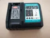 A black and teal battery charger with indicator lights and symbols on a light gray surface. Produktbild-Vorschau