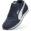 A close-up, studio shot of a single navy blue Puma sneaker with a white stripe. Produktbild-Vorschau