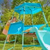 A young girl is playing on a colorful outdoor playground structure. Produktbild-Vorschau