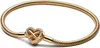 A gold-colored bracelet with a heart-shaped charm featuring an infinity symbol and small clear stones, presented on a white background. Produktbild-Vorschau