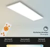 A white LED panel light is shown mounted on a ceiling, with a remote control in the foreground. The image also displays text and icons indicating dimmable features and color temperature options. Náhľad obrázku produktu