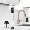 A hand blender and its chopper attachment are displayed on a kitchen counter next to a faucet. Produktbild-Vorschau