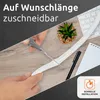A person is cutting a white cable sleeve with scissors on a wooden desk, with a keyboard and a small plant in the background. Produktbild-Vorschau