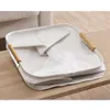 A folded laundry basket with wooden handles sits on a wooden table. Náhľad obrázku produktu