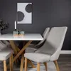 A dining table with chairs in a modern setting. Produktbild-Vorschau