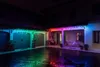 A house exterior at night, decorated with colorful LED icicle lights. Náhled obrázku produktu