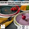 A collection of colorful porcelain plates and bowls, some with food items like tomatoes and onions. Anteprima dell’immagine prodotto