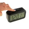A hand presses a button on a digital alarm clock. Náhled obrázku produktu