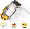 A close-up product shot of a safety face shield with a yellow strap and several circular badges at the bottom. Náhled obrázku produktu
