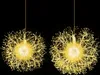 Two illuminated dandelion-shaped light spheres hanging against a black background. Voir les images du produit