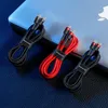 Three charging cables are arranged on a dark blue surface, with a light blue object in the background. Produktbild-Vorschau