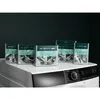 Several boxes of AEG washing machine cleaner are arranged on top of a washing machine. Produktbild-Vorschau