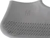 A close-up of a gray shoe cover with a textured sole and the letter 'M' embossed on it. Náhľad obrázku produktu