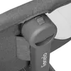 A close-up view of a gray fabric and plastic mechanism on a baby crib. Produktbild-Vorschau
