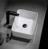 A white ceramic vessel sink with a black faucet and drain. Podgląd zdjęcia produktu