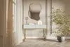 A white console table with gold legs is placed in a room with a large mirror above it and a potted plant next to it. Anteprima dell’immagine prodotto