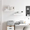 A clean, minimalist office or study space with shelves, a printer, and a desk. Voir les images du produit