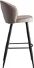 A side view of a beige velvet bar stool with black metal legs against a white background. Voir les images du produit