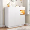 A white shoe cabinet with a wood-accented open shelf, placed in a hallway or entryway. Anteprima dell’immagine prodotto