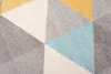 A close-up view of a geometric patterned rug. Náhľad obrázku produktu