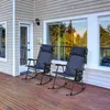 Two blue rocking chairs on a wooden deck outside a house. Produktbild-Vorschau