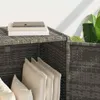 A close-up view of a gray poly rattan garden storage box with cushions inside. Voir les images du produit