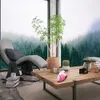 A mini iron on a wooden coffee table in a modern living room with a large window overlooking a forest. Produktbild-Vorschau