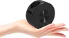 A small black projector is held in an open palm. Produktbild-Vorschau
