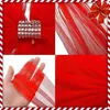 A collage of four images showing a red Christmas ribbon with a gold and silver buckle, a close-up of the ribbon material, a hand holding the ribbon, and a solid red background. Náhled obrázku produktu