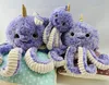 Three purple octopus plush toys are arranged on pillows. Produktbild-Vorschau