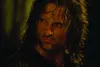 A close-up shot of a man's face with long, dark, wet hair. Podgląd zdjęcia produktu