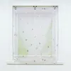 A white window frame with a sheer white roman shade with silver triangle pattern. Produktbild-Vorschau