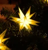 Close-up of yellow star-shaped LED lights on a Christmas tree. Produktbild-Vorschau
