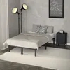 A bedroom scene with a bed, nightstand, and lamps. Podgląd zdjęcia produktu