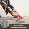A person is installing flooring, with a close-up of water droplets on a textured surface in the lower left corner. Náhled obrázku produktu