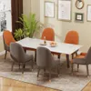 A dining room scene with a marble-look table and chairs, set for a meal. Produktbild-Vorschau
