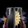 Hands holding a transparent protective case for a foldable smartphone, showing the phone's camera array and screen. Podgląd zdjęcia produktu