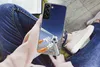 A person holding a smartphone with a soccer-themed case. Produktbild-Vorschau